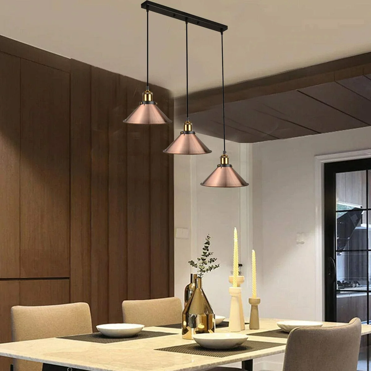 Vintage industrial pendant light with three rose gold metal shades hanging from adjustable cords on ceiling fitting