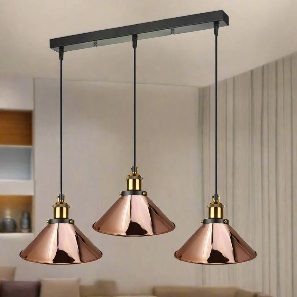 Vintage industrial style 3 head ceiling light with rose gold metal pendant shades and adjustable cords hanging from ceiling rose