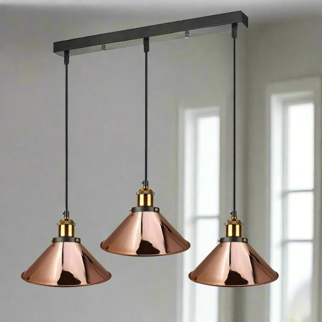 Three-head rose gold metal pendant lamp with adjustable cords and E27 bulb fittings hanging from ceiling rose