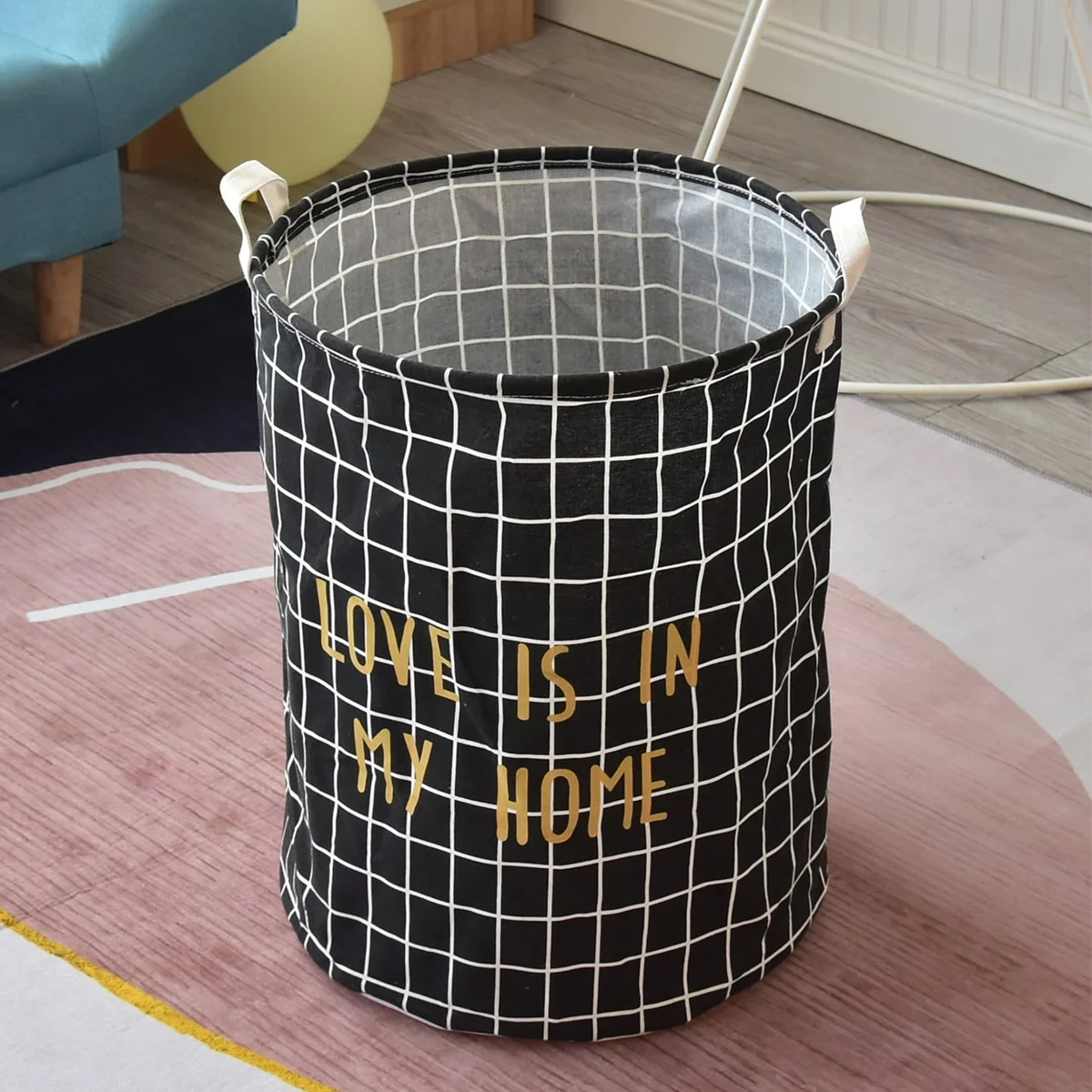 Two large laundry bags in black and white cotton with foldable design and waterproof inner layer, shown side by side