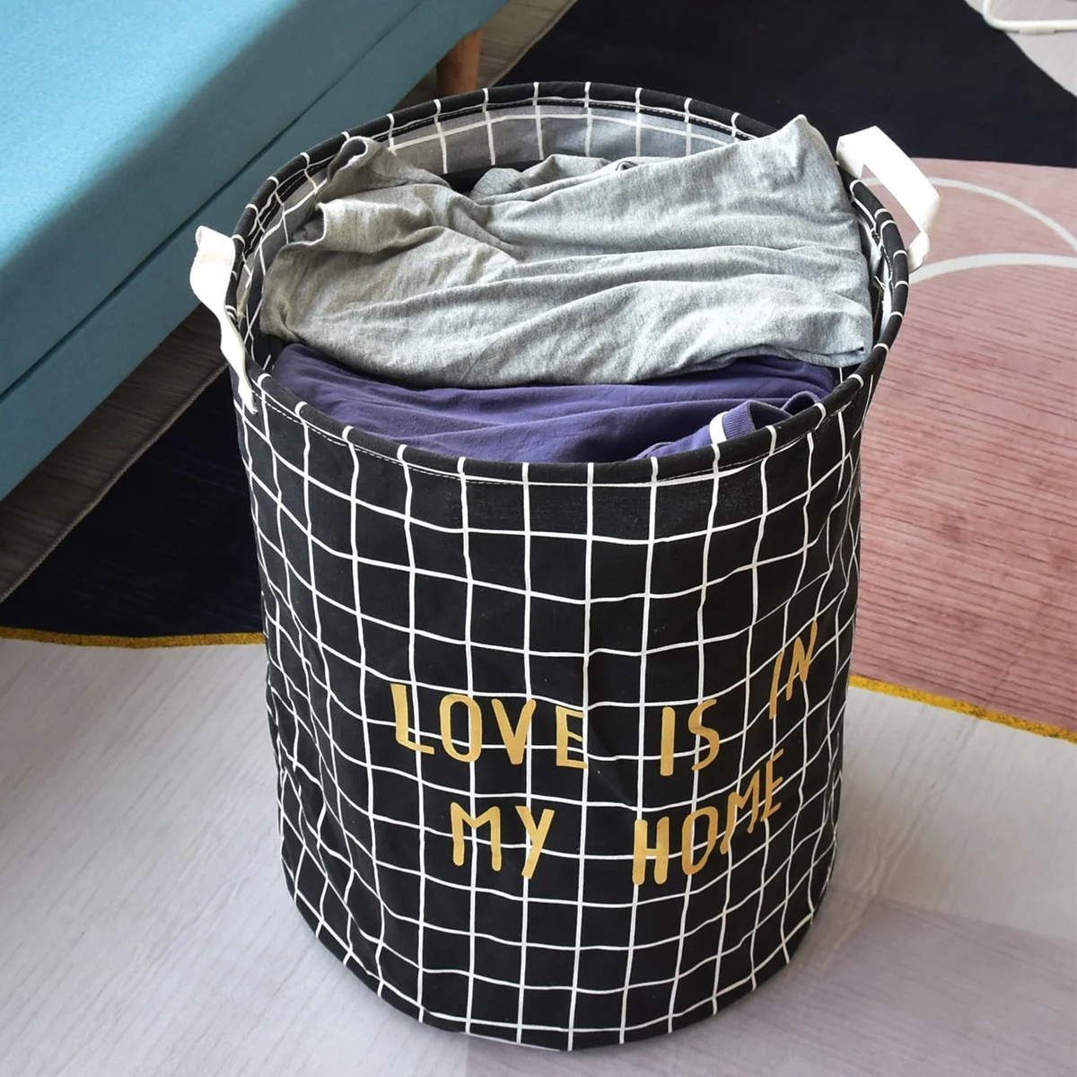 Two large black and white foldable cotton laundry bags with waterproof lining, shown standing upright side by side