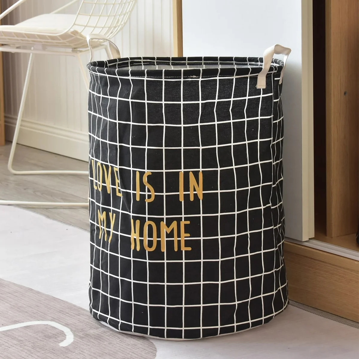 Two large black and white laundry bags with foldable design and waterproof interior, placed side by side on floor