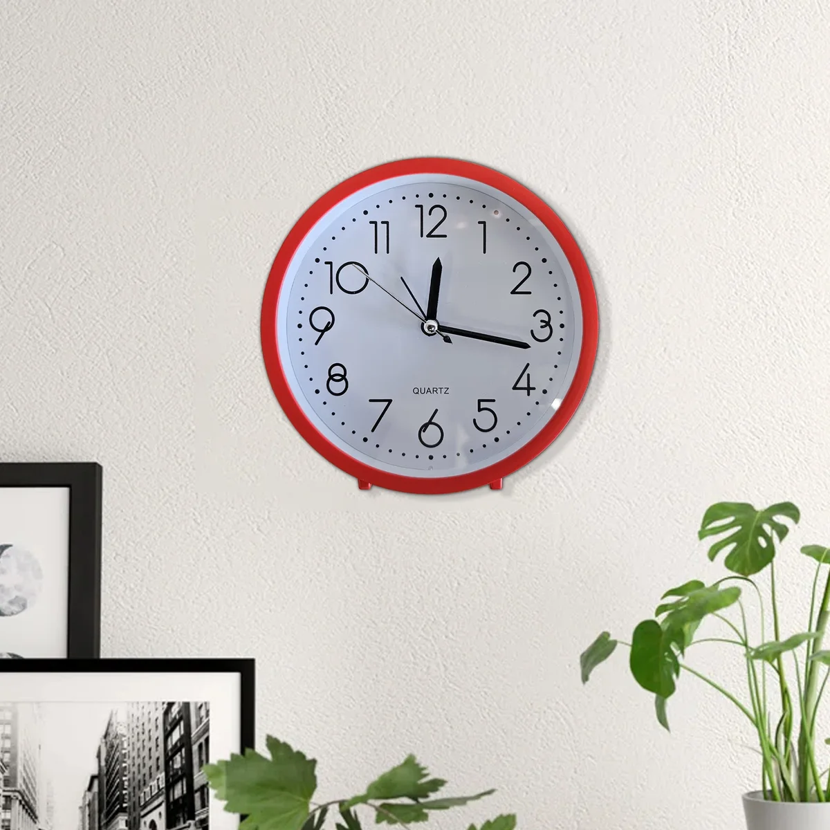 Retro analog alarm clock with vintage design, white numerals, black frame, and soft night light on table against white background