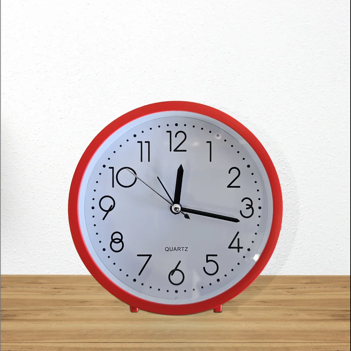 Retro style analog alarm clock on wall showing eye-care night light glowing softly around white numerals