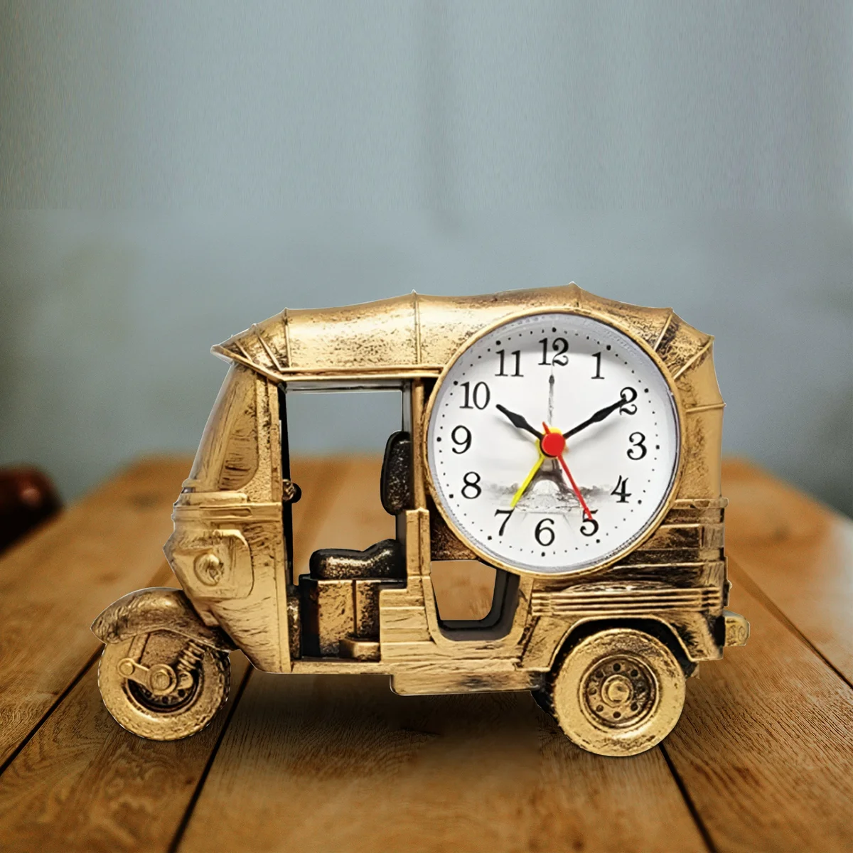 Modern three wheeler clock in plastic with analogue display, designed as a unique desktop alarm clock gift