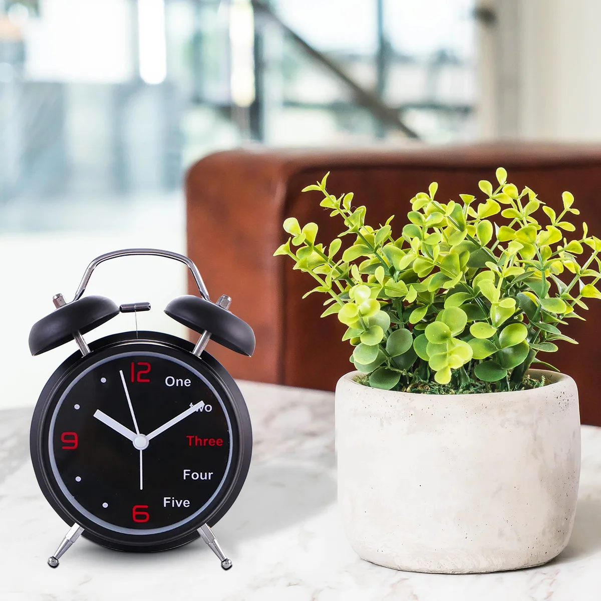 Retro-style double bell alarm clock with twin metal bells, round face, and clear analog numbers on a white background