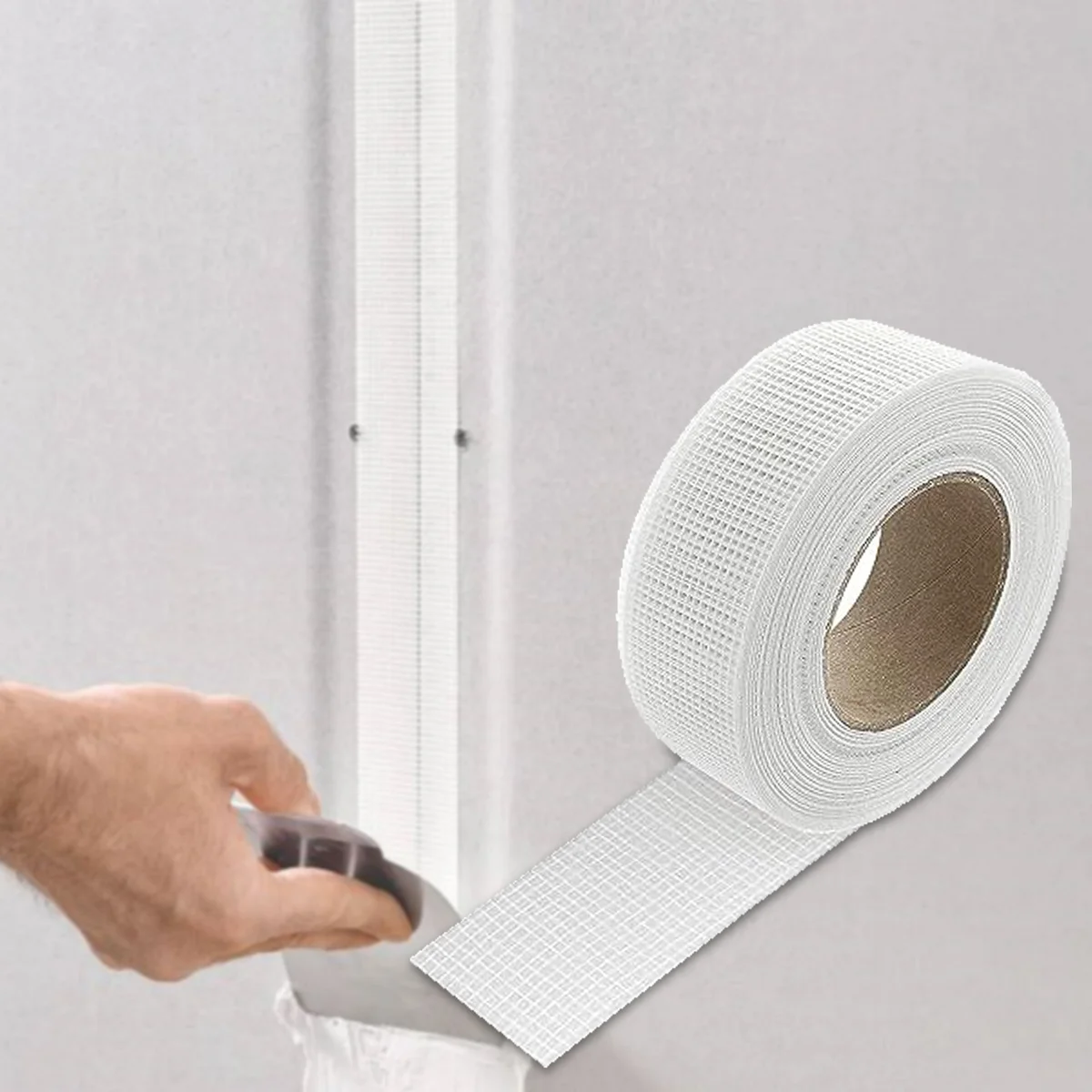 Roll of professional self-adhesive fiberglass mesh tape for drywall joint repair, 50mm wide and 45m long