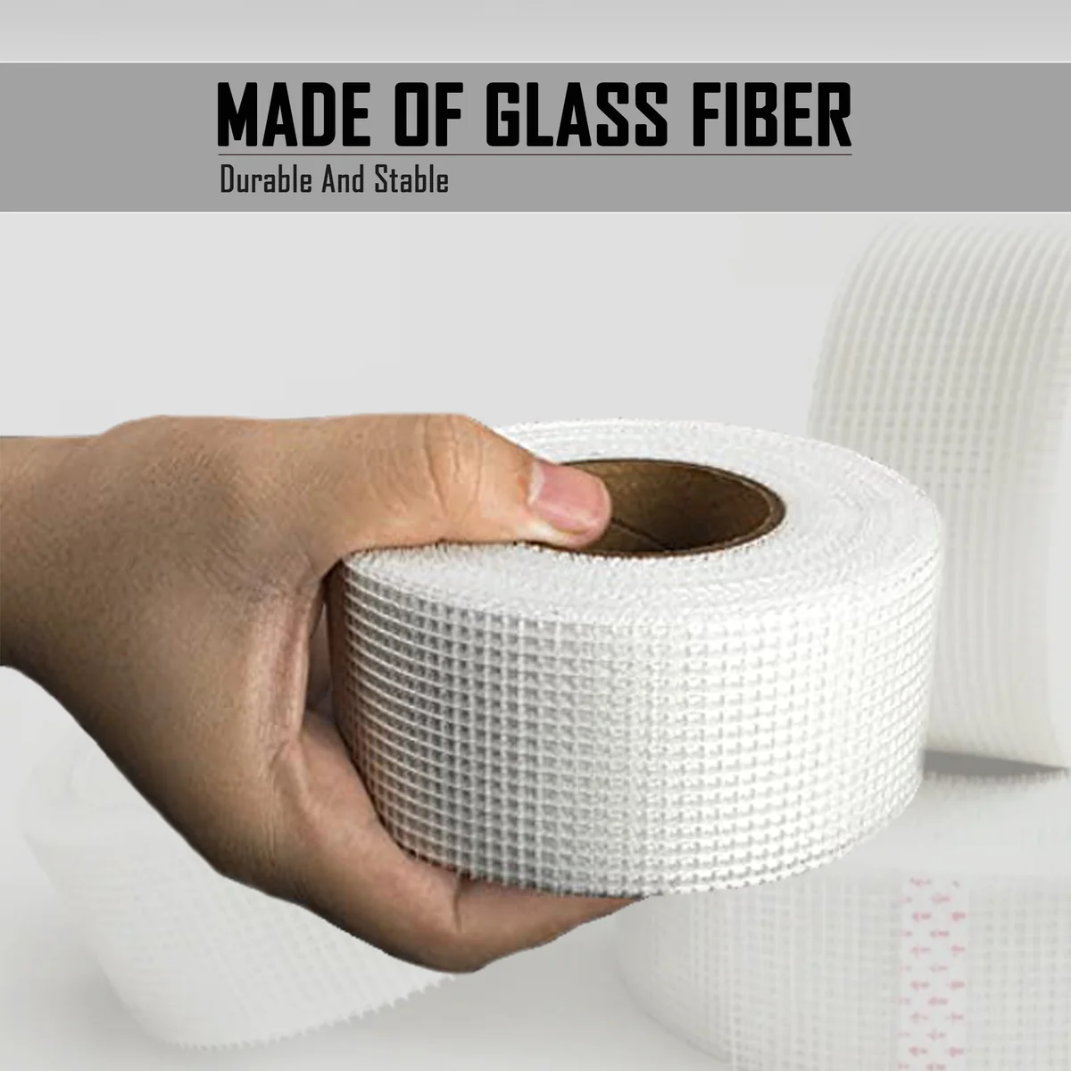 Roll of professional self-adhesive fiberglass mesh tape for drywall joint repair, 50mm wide and 45m long