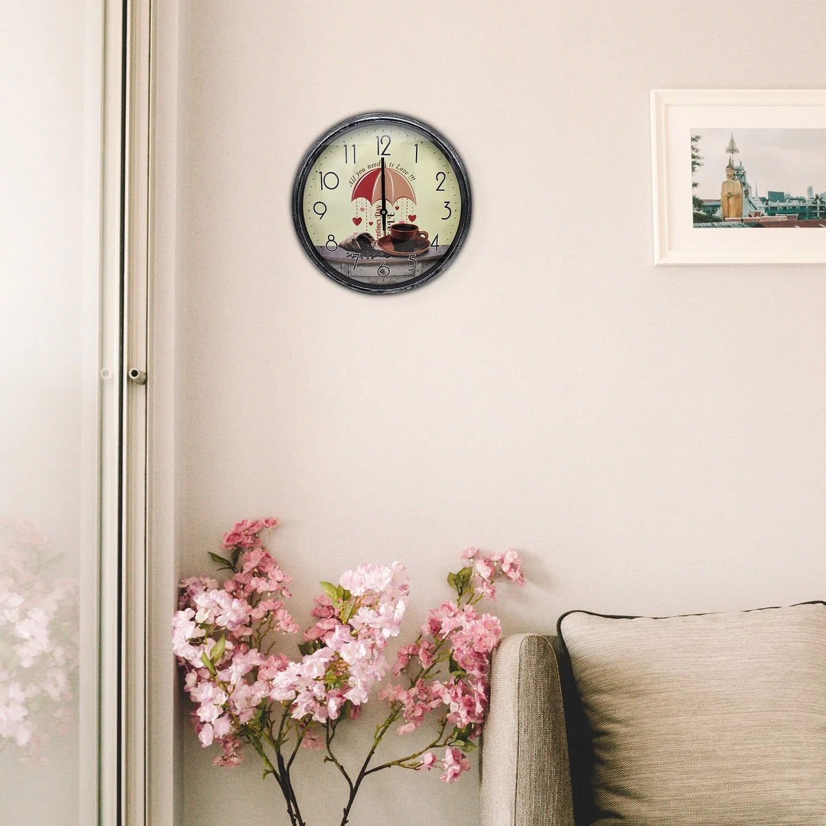 Round shabby chic wall clock with colorful patchwork design, wooden frame, and metal hands on white background