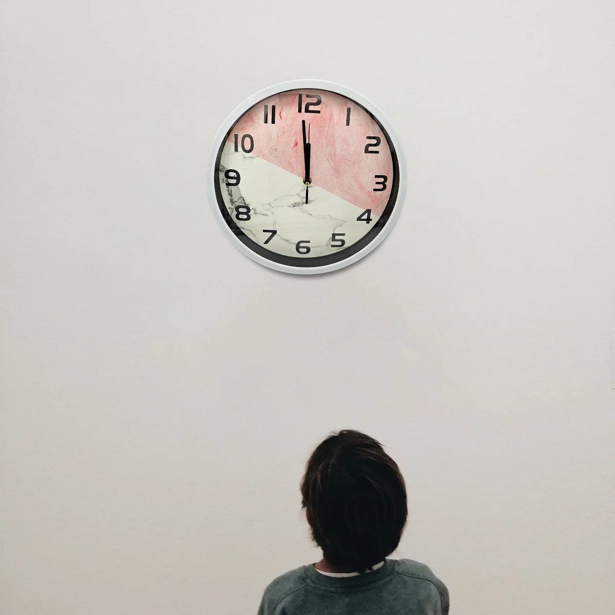 Round metal analog wall clock with vintage-modern design, black frame, white face, and easy-to-read numbers on wall