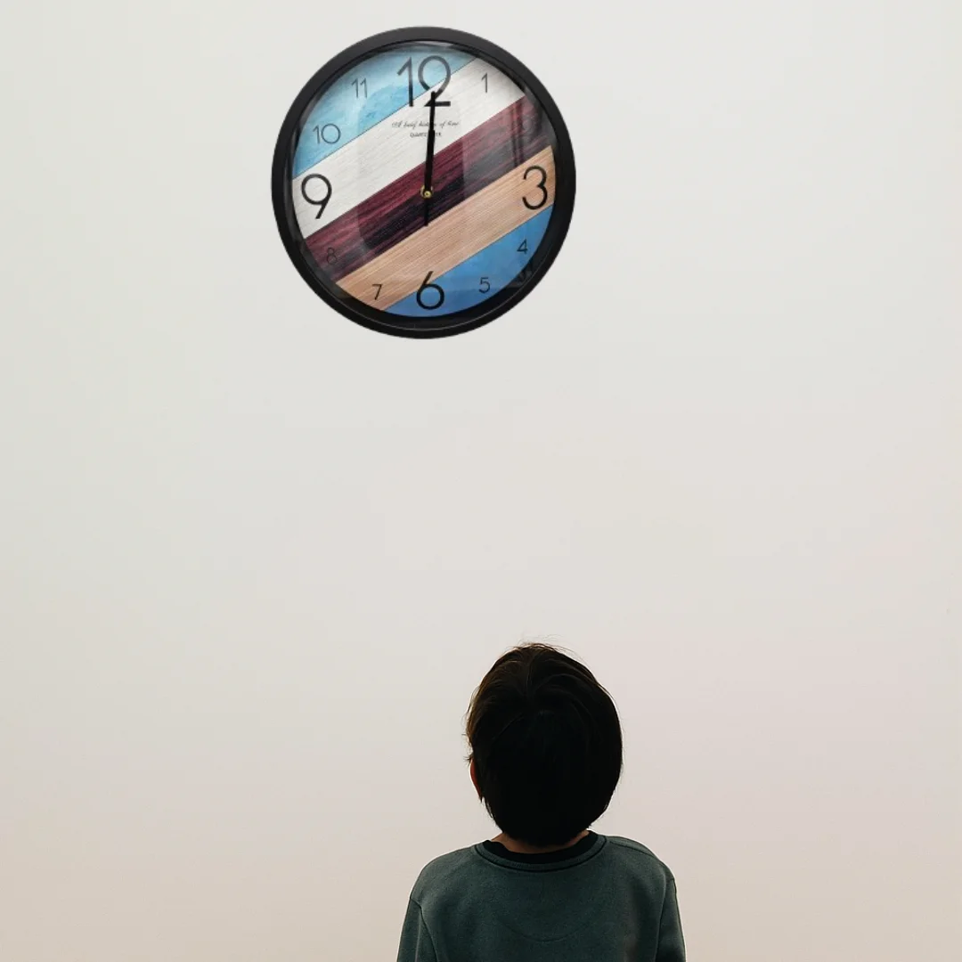 Modern quartz wall clock with colourful numbers and hands on a round, sleek, shiny plastic and glass face, 30 cm diameter