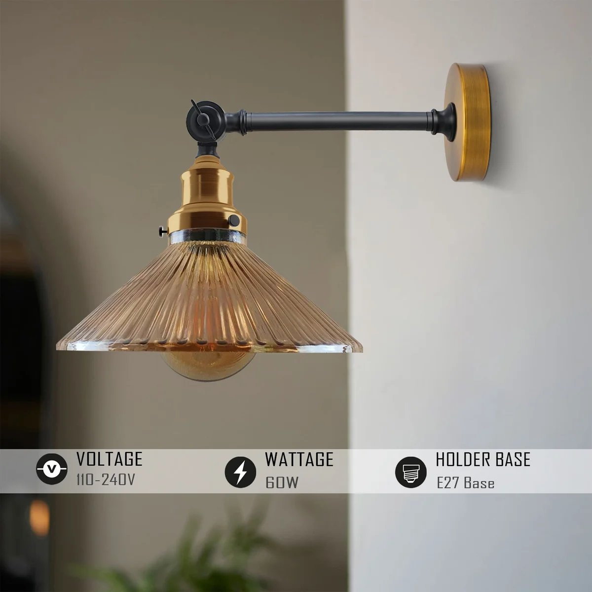Adjustable brass wall light with amber ribbed glass shade and black arm, mounted on a 12cm round ceiling rose