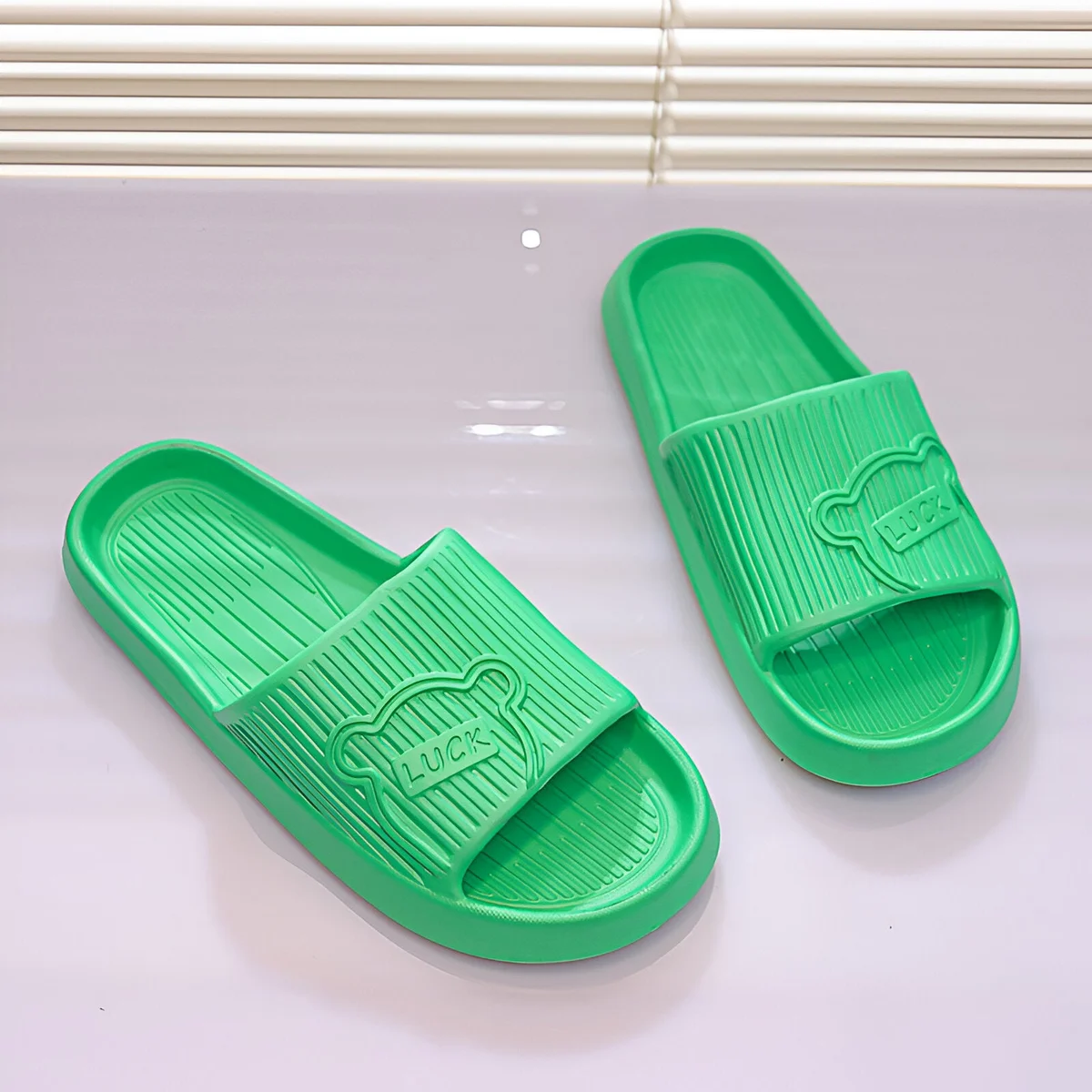 Pair of unisex lightweight EVA flip flop slippers in black with ergonomic design and non-slip soles on white background