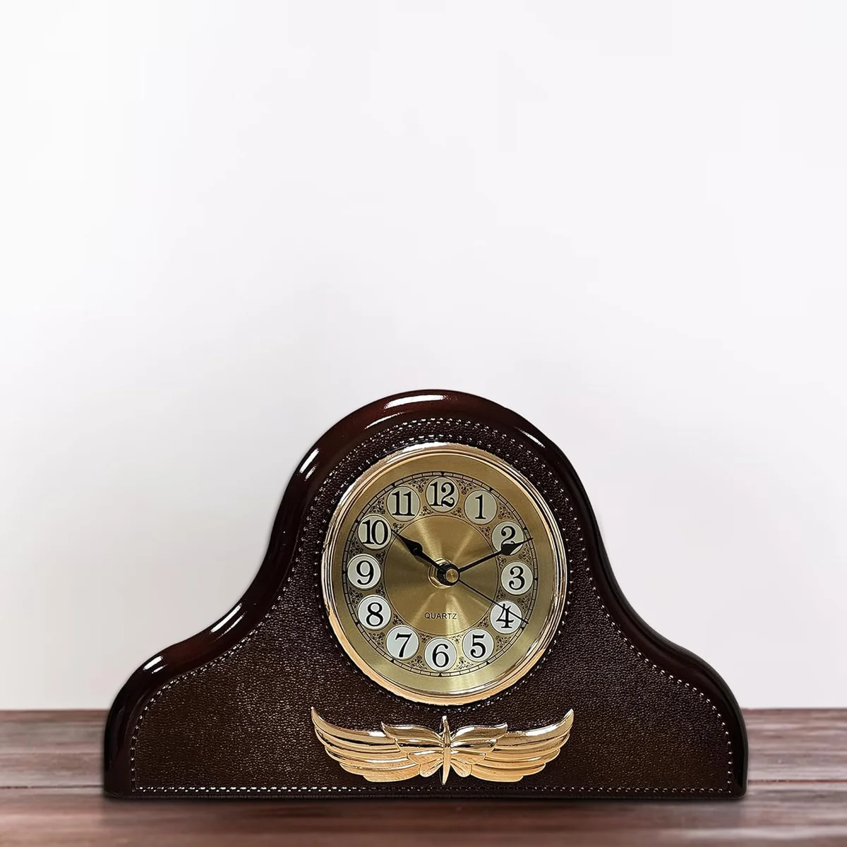 Leather mantel clock in Napoleon style with large black numbers on white face, round design with leather accents on shelf