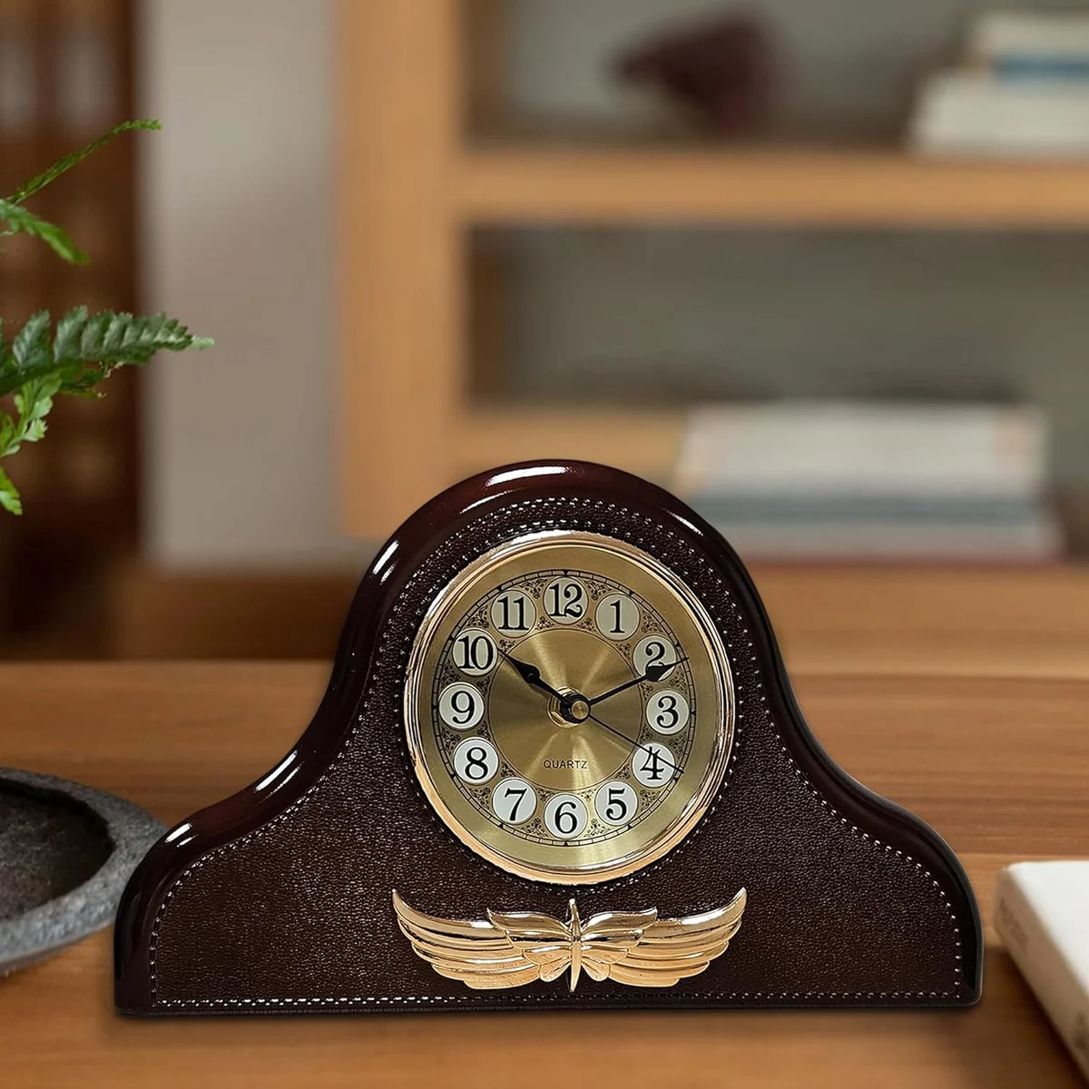 Leather Napoleon style clock with large black numbers on white face and vintage leather accents on mantel design