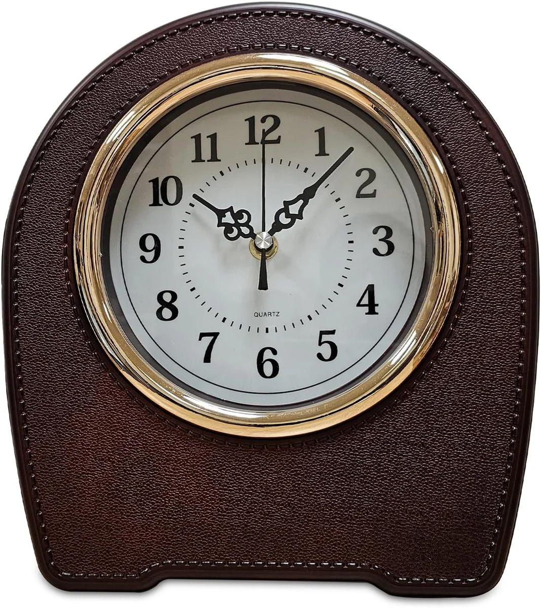 Vintage style small mantel living room clock with black leather finish on a wooden desktop table