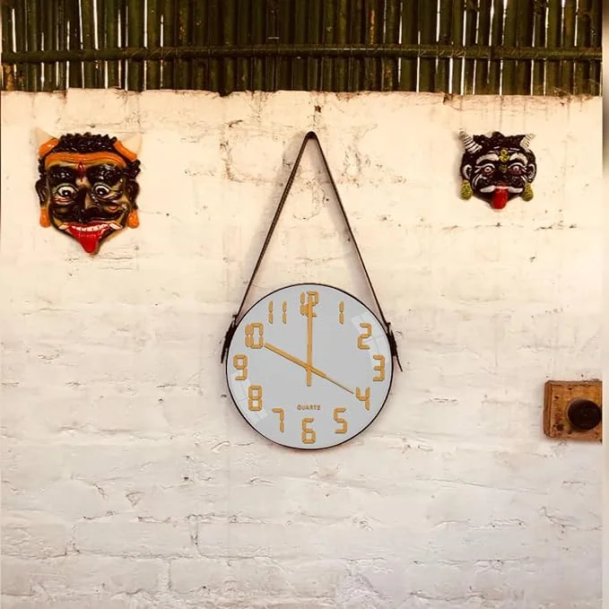 Modern wall clock with round concrete face, brown leather strap hanger, glass cover, and black hour markers on white background