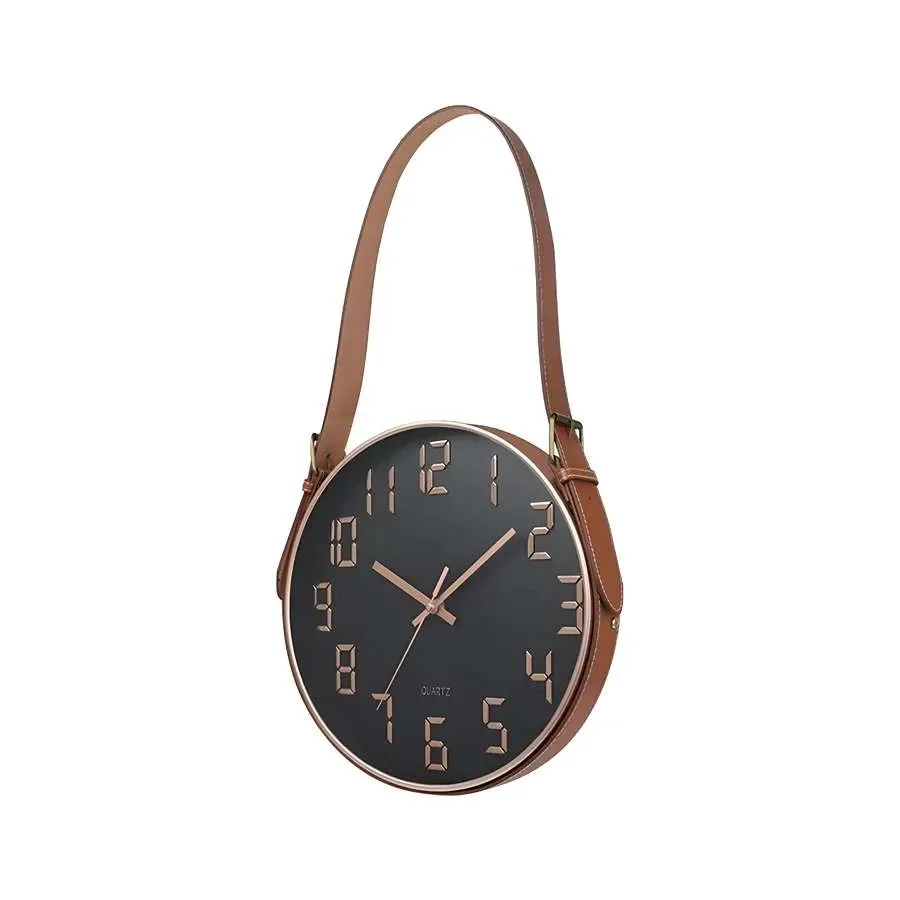 Modern wall clock with round concrete face and brown leather strap hanging on white wall, sleek and minimalist design