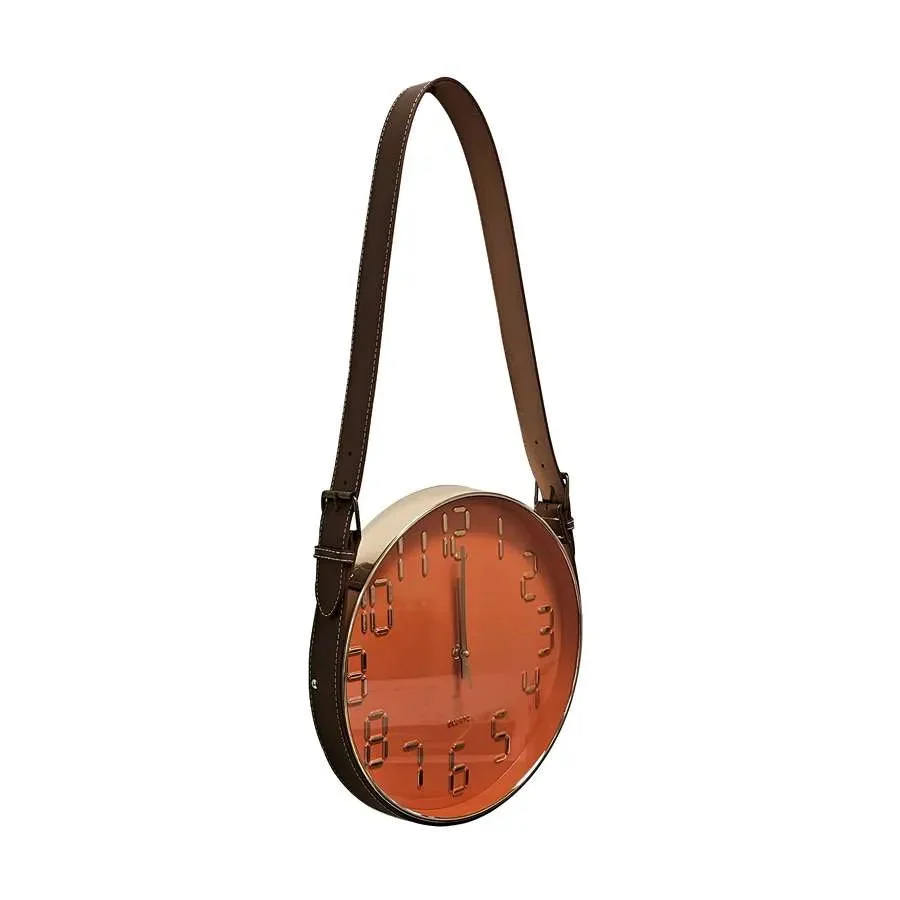 Modern wall clock with round concrete face and brown leather strap hanging on a white wall, showing black hour markers.