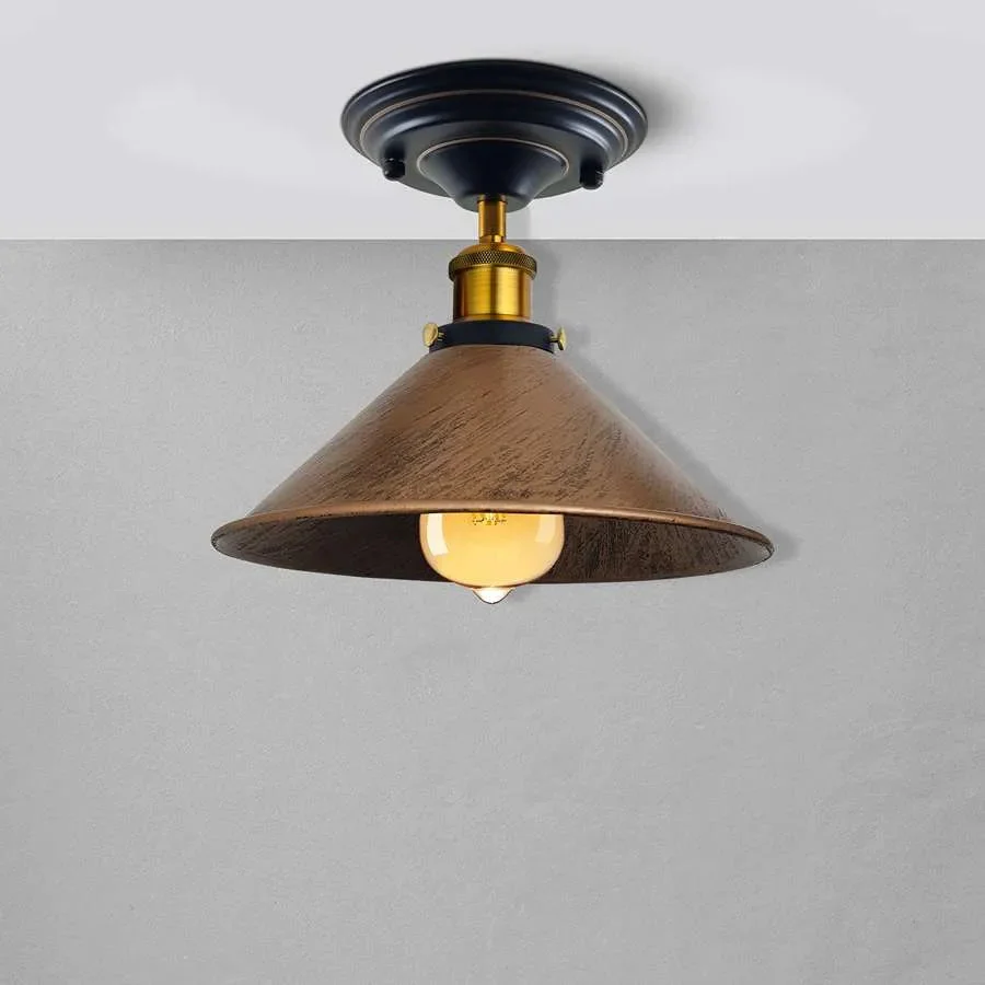 Rust resistant pendant with metal cone shade in brushed copper, hanging from ceiling with sleek design.