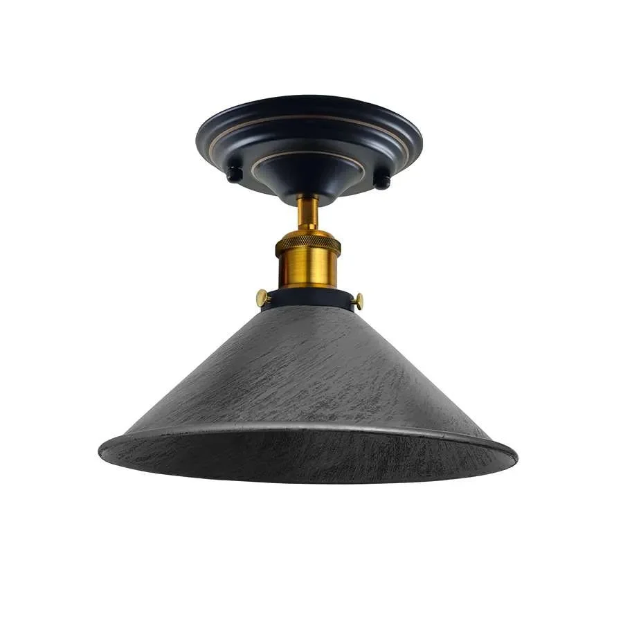 Rust-resistant metal cone industrial pendant light with brushed silver shade, mounted in a yellow brass fixture.