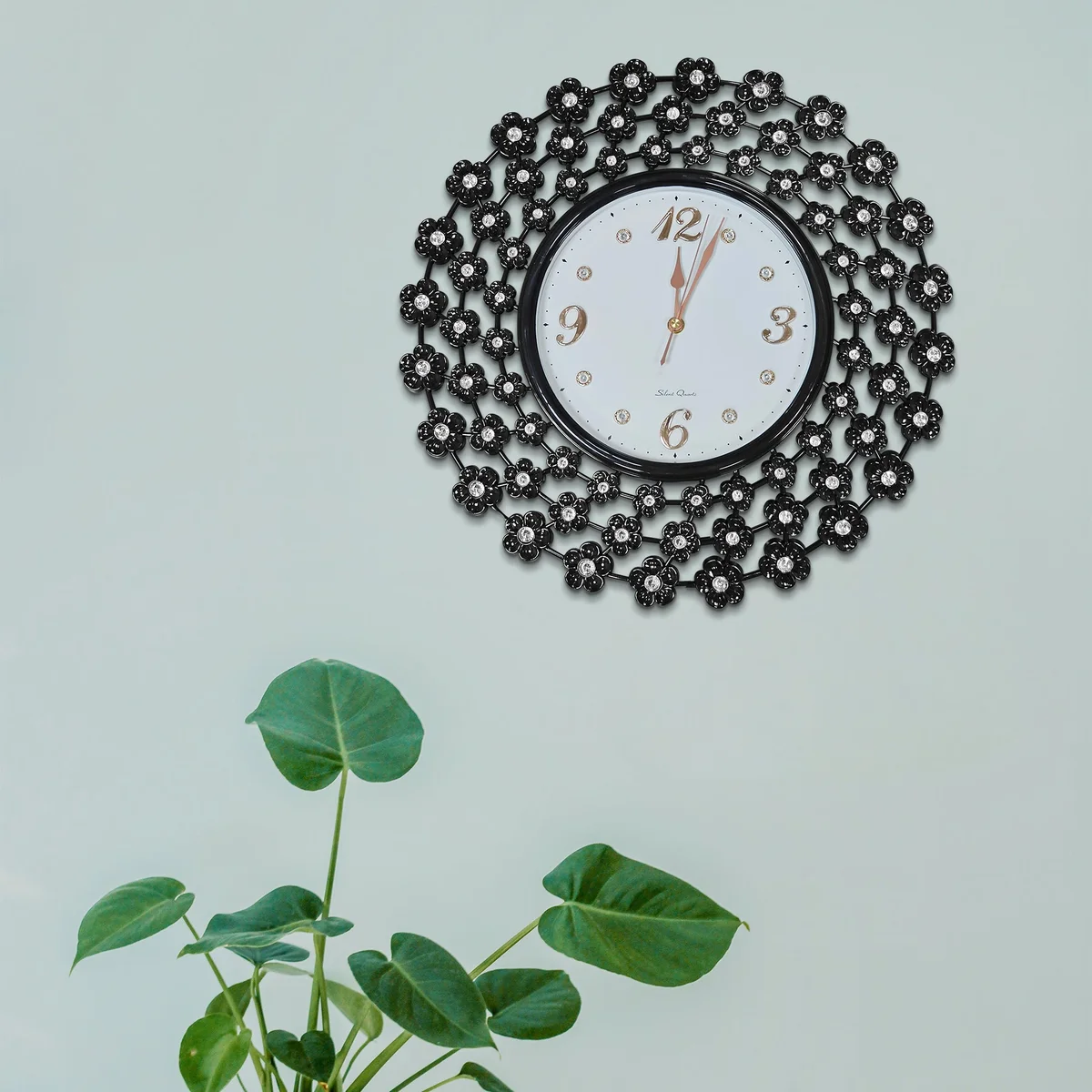 Black retro wall clock with intricate decorative flower design on metal frame, 45 cm diameter, battery powered