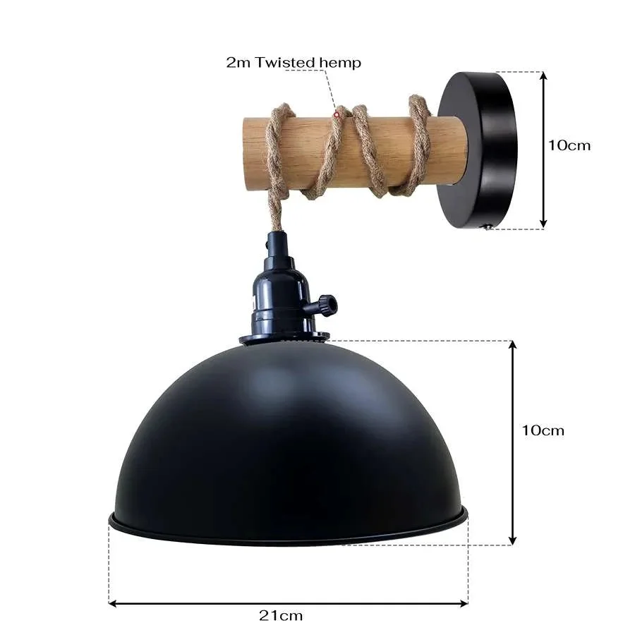 Vintage farmhouse wall lamp with wooden arm and metal dome shade hanging against a neutral background
