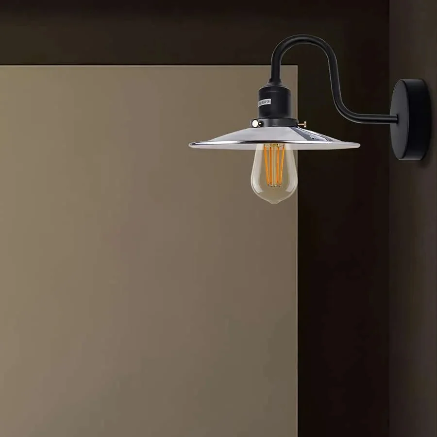 Industrial wall light with curved swan neck arm, metal finish, and E27 bulb socket mounted on a white wall