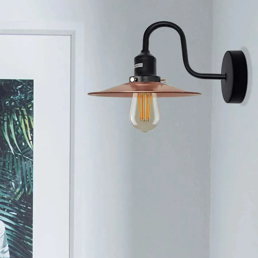 Industrial wall light with curved swan neck arm, metal finish, and E27 bulb fitting mounted on a white wall