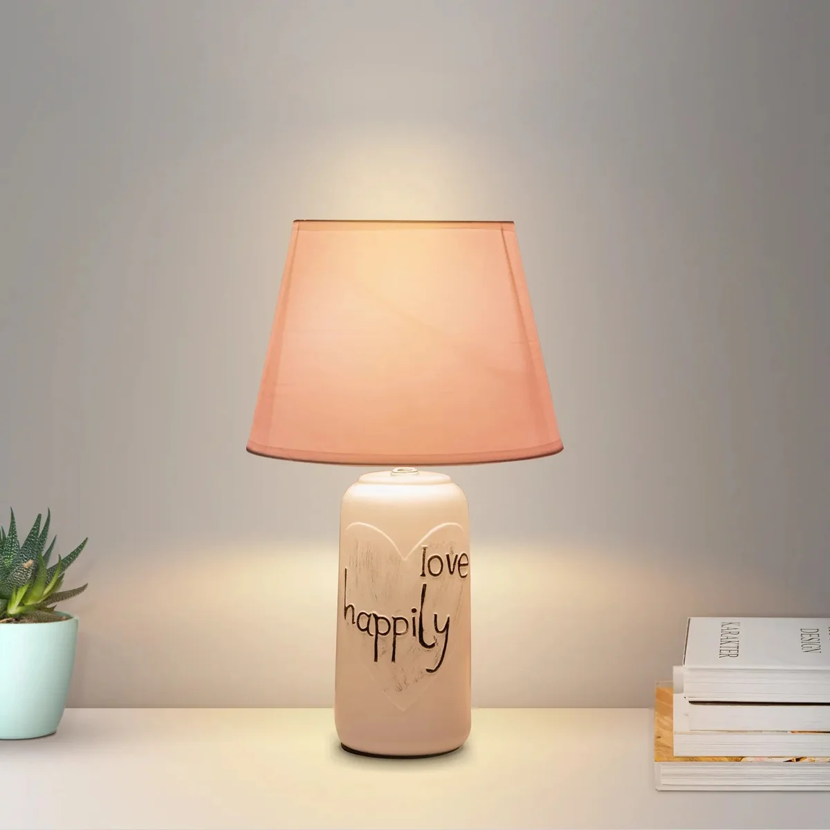 Elegant bedside table lamp with ceramic base and fabric shade, ideal for bedroom or living room lighting.