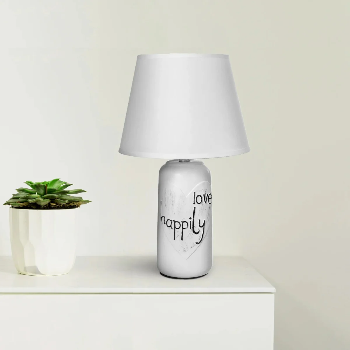 Ceramic base lamp with fabric shade on bedside table, soft warm light, minimalist elegant design for bedroom or office