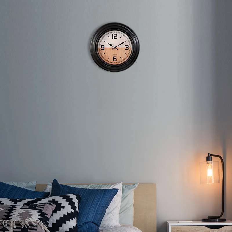 Black round wall clock with vintage style, large clear numbers and hands, shiny plastic surface, for living room decor