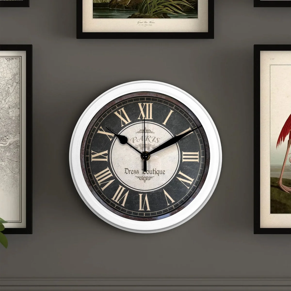 Black round large vintage wall clock with clear numbers and hands, sleek plastic surface, hanging on a living room wall