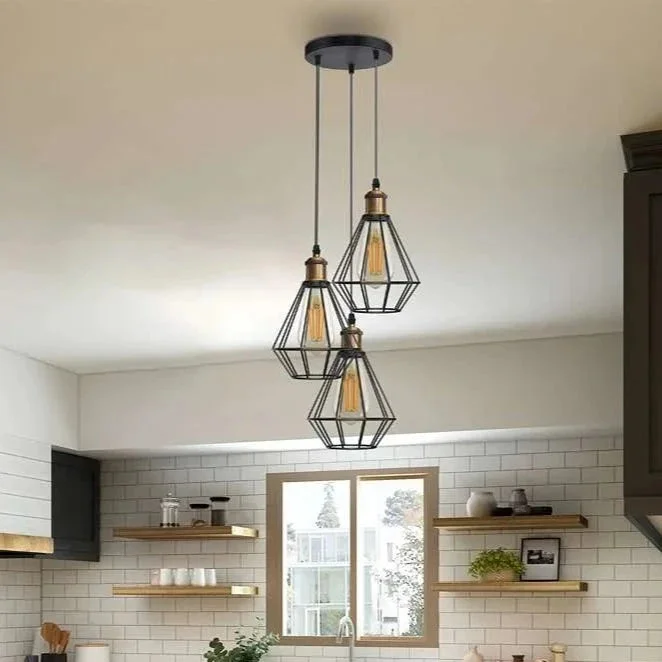 Black wire cage pendant light with three diamond-shaped metal cages hanging from adjustable black PVC cords