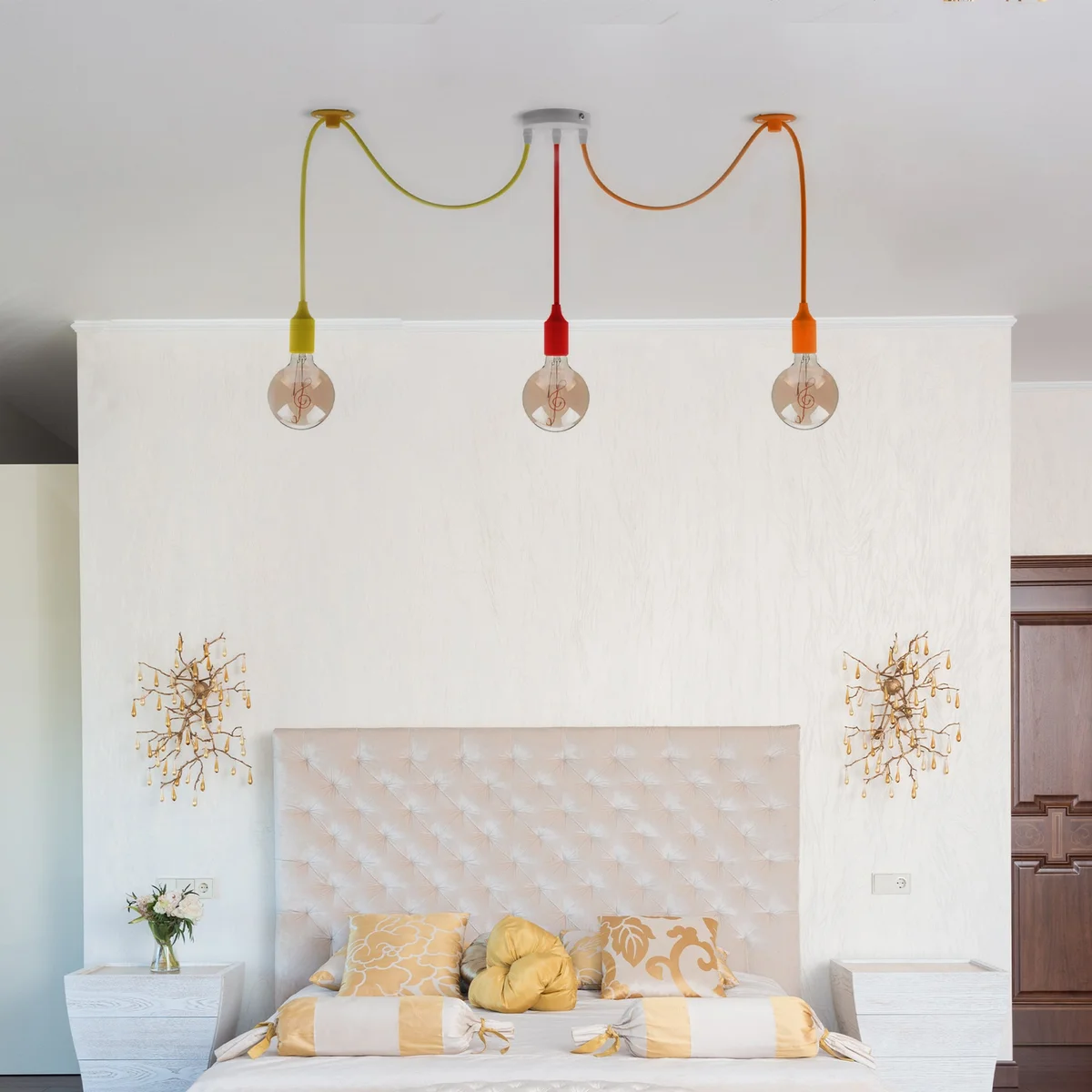 3 head multi-color pendant light with adjustable fabric cables and metal fixtures hanging from ceiling rose