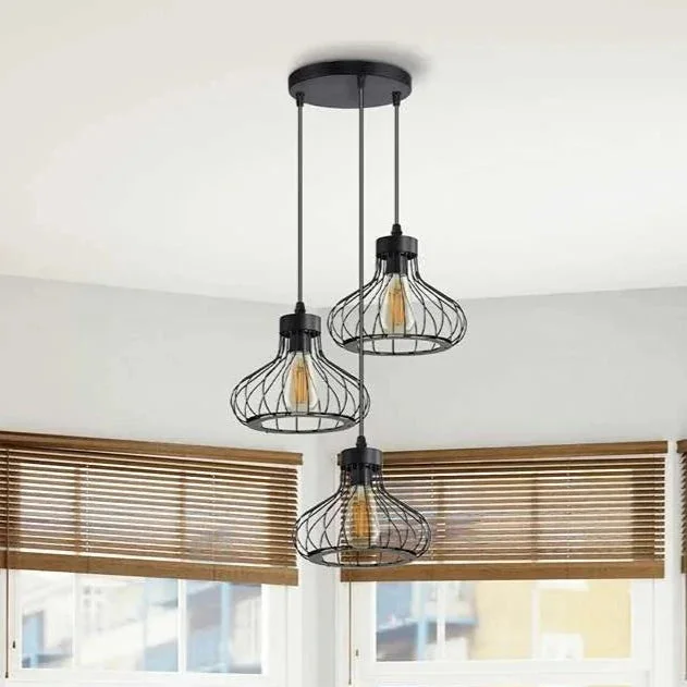 Black industrial pendant light with three matt black wire cage shades hanging from adjustable cables