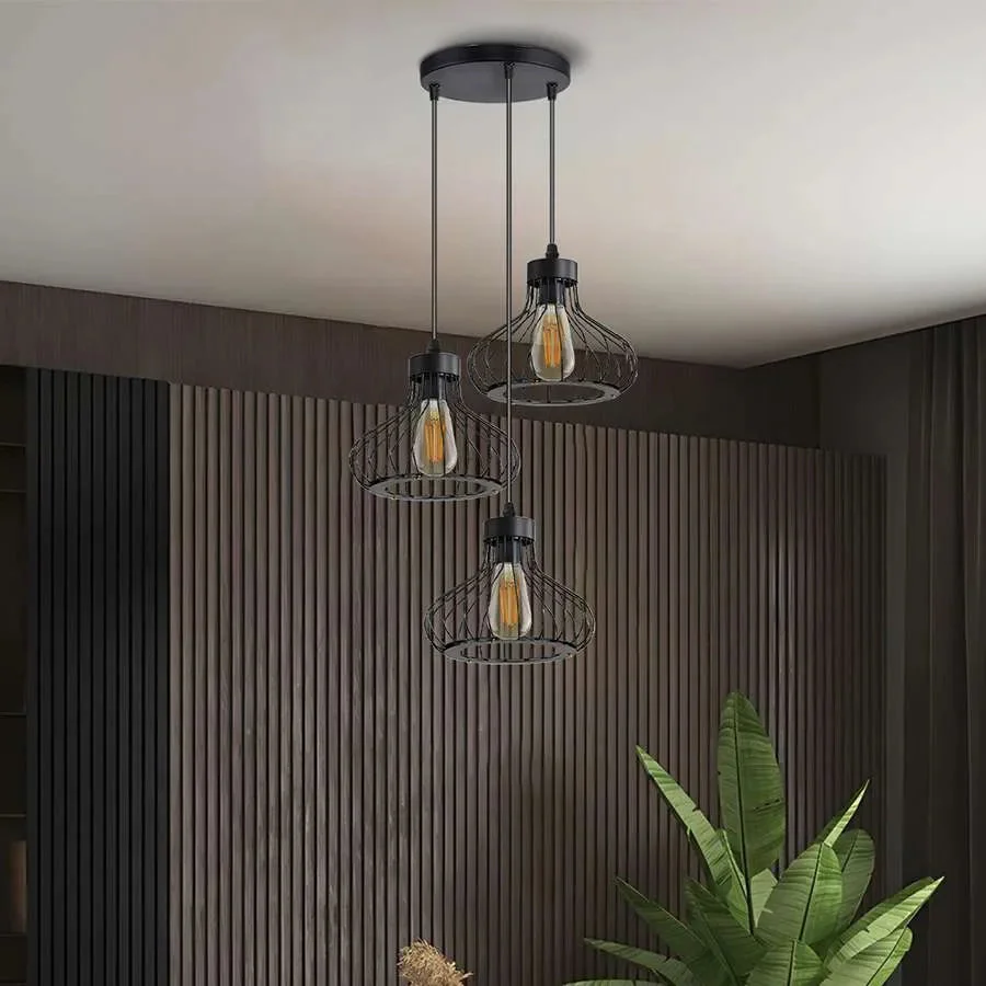 Three-light matt black cage pendant with adjustable cables and metal wire cages in industrial style hanging from ceiling