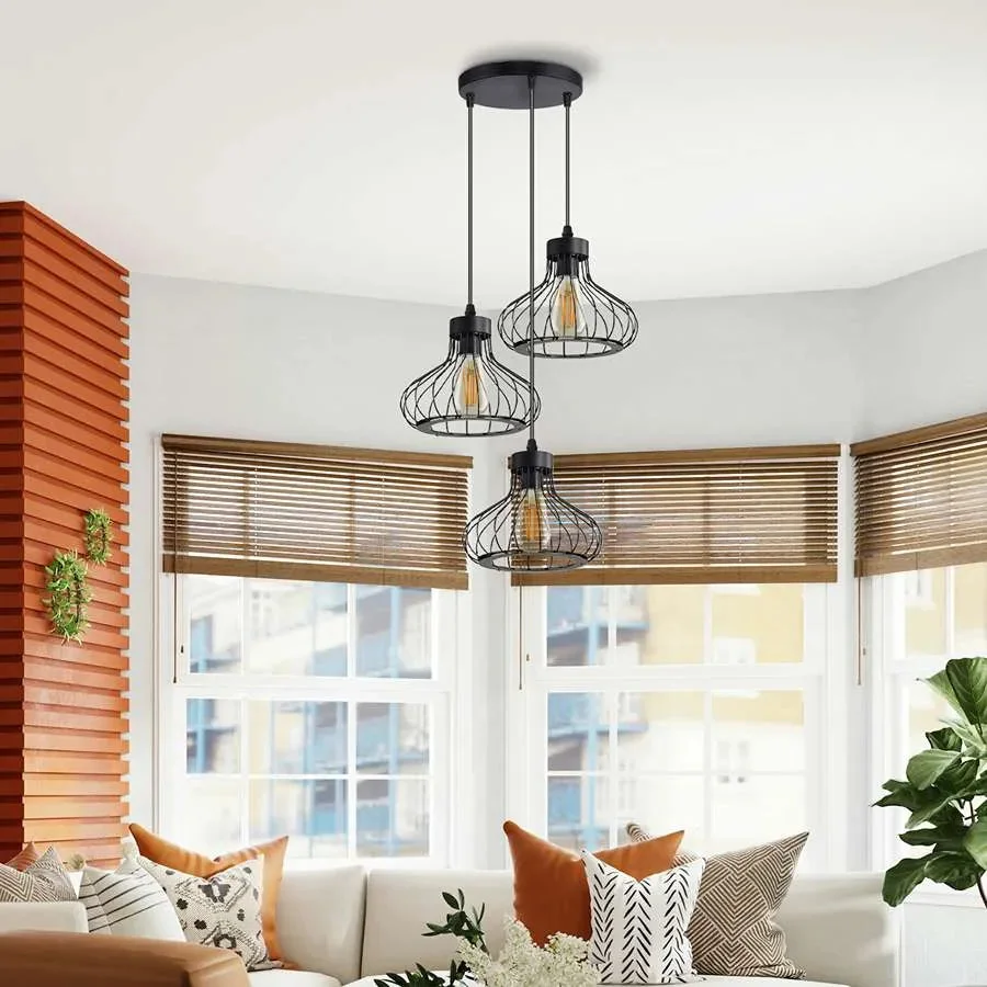 Black industrial pendant light with three matt black wire cages and adjustable cables hanging from ceiling fixture
