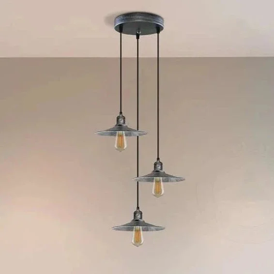 3 light pendant lamp with metal shades hanging from a ceiling, featuring industrial/retro design.