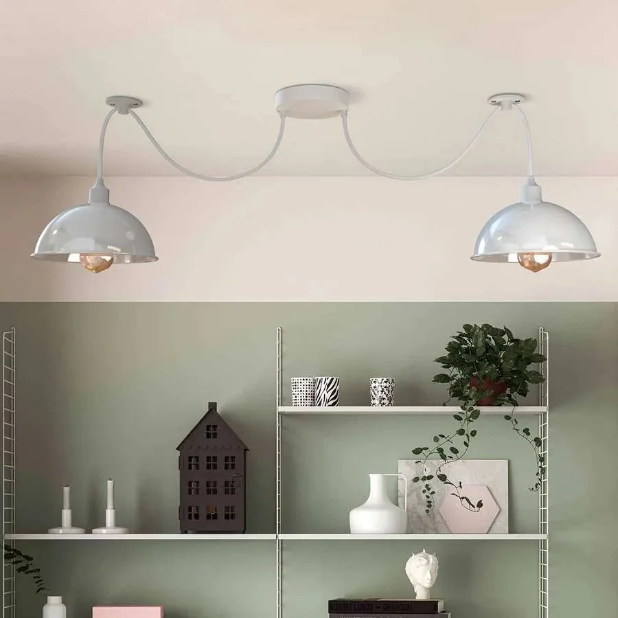 White industrial spider pendant light with two adjustable metal shades hanging from ceiling cables