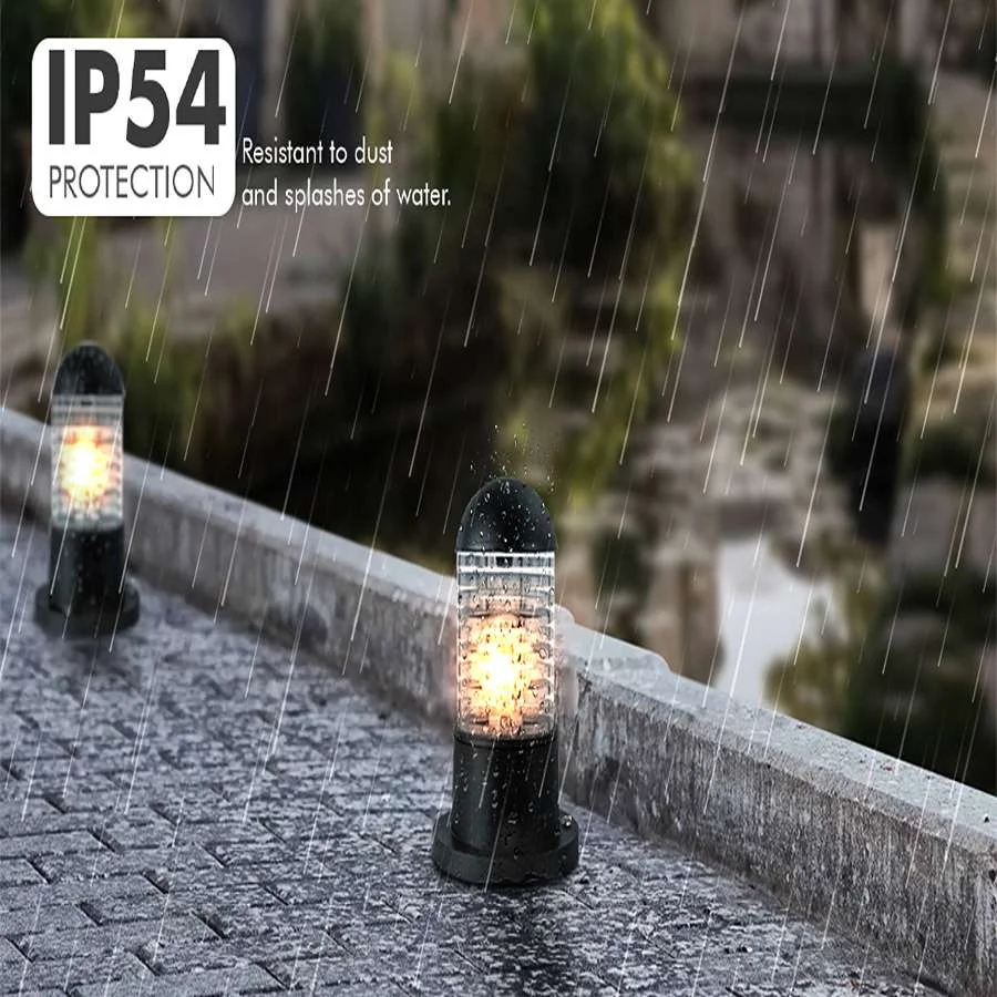 Black modern exterior pillar light with cylindrical glass shade and rippled design, mounted on garden post outdoors