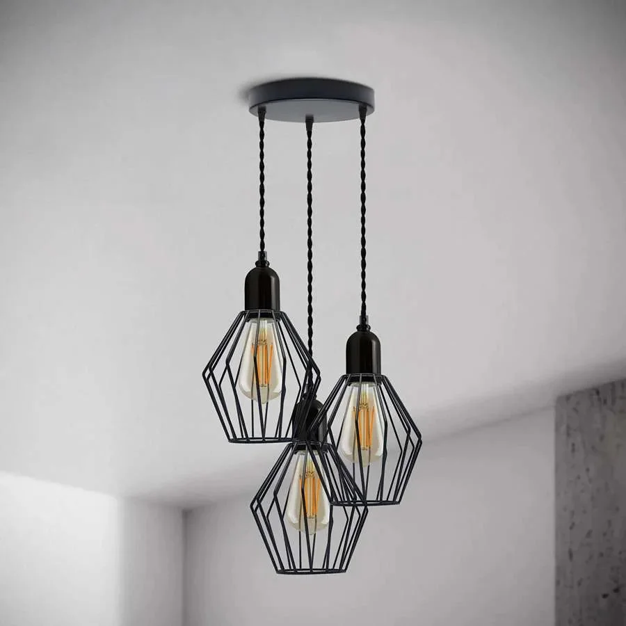Black industrial 3 light cluster pendant with wire cage shades and adjustable twisted cord hanging from ceiling rose