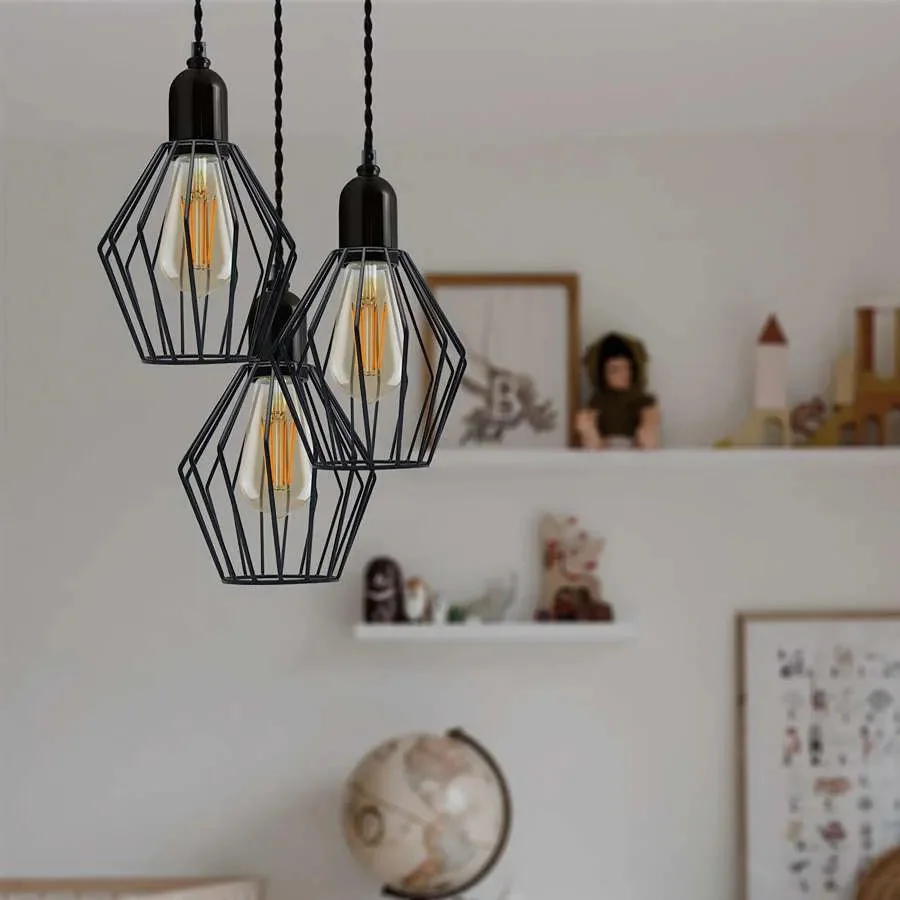Black 3-light cluster industrial pendant light with wire cage shades hanging from twisted cords against white background