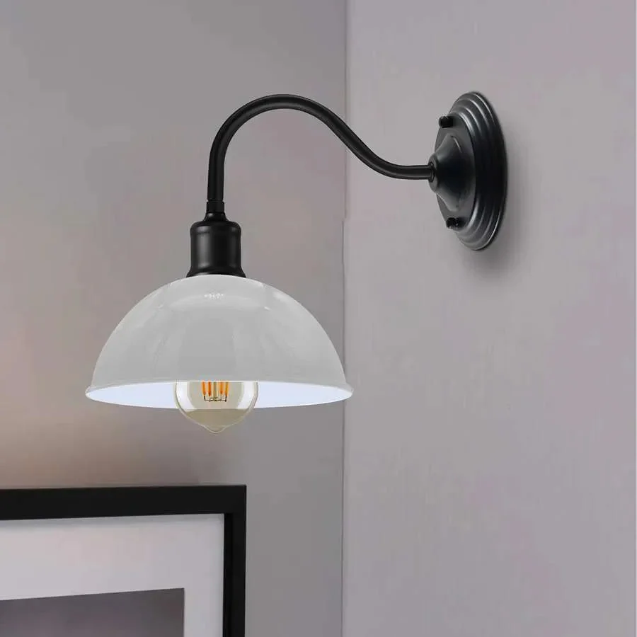 Industrial swan neck wall light with curved arm and metal dome shade in vintage industrial style against white background