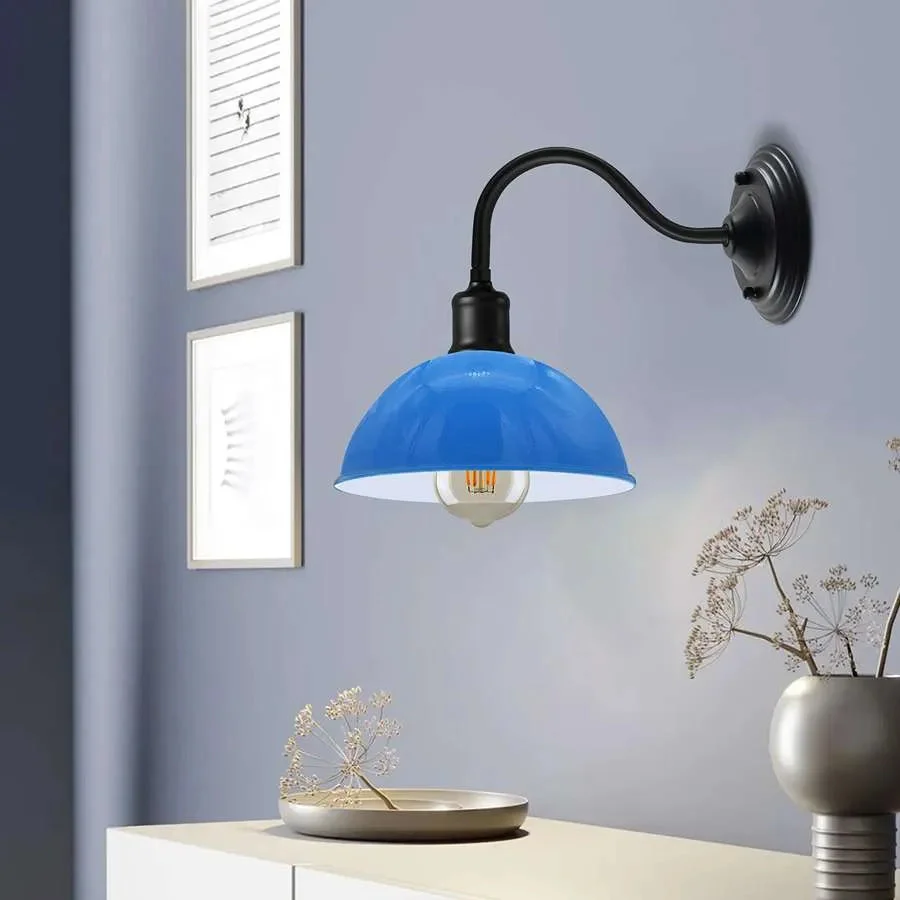 Industrial wall lamp with curved swan neck arm and metal dome shade mounted on a wall with E27 bulb holder visible