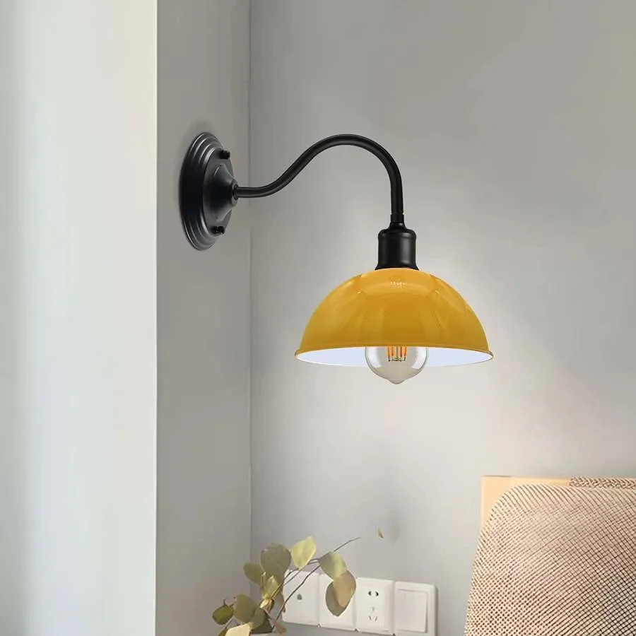 Industrial wall lamp with curved swan neck arm and metal dome shade in vintage industrial style mounted on wall
