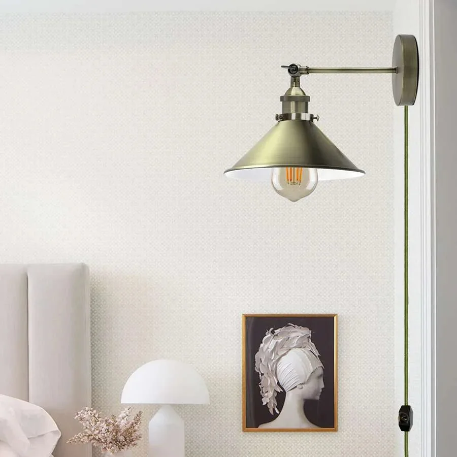Industrial wall light with metal cone shade, adjustable arm, fabric cable, and dimmer switch plug-in design