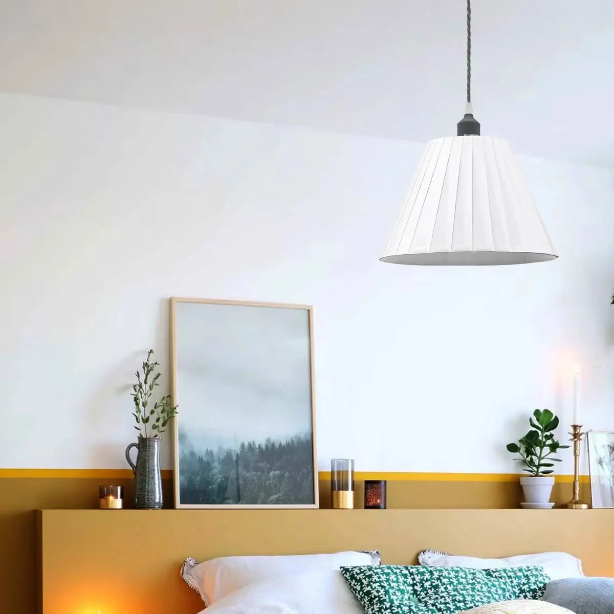Modern pendant light with white pleated fabric lampshade and metal fixture, hanging from ceiling with fabric-covered cable
