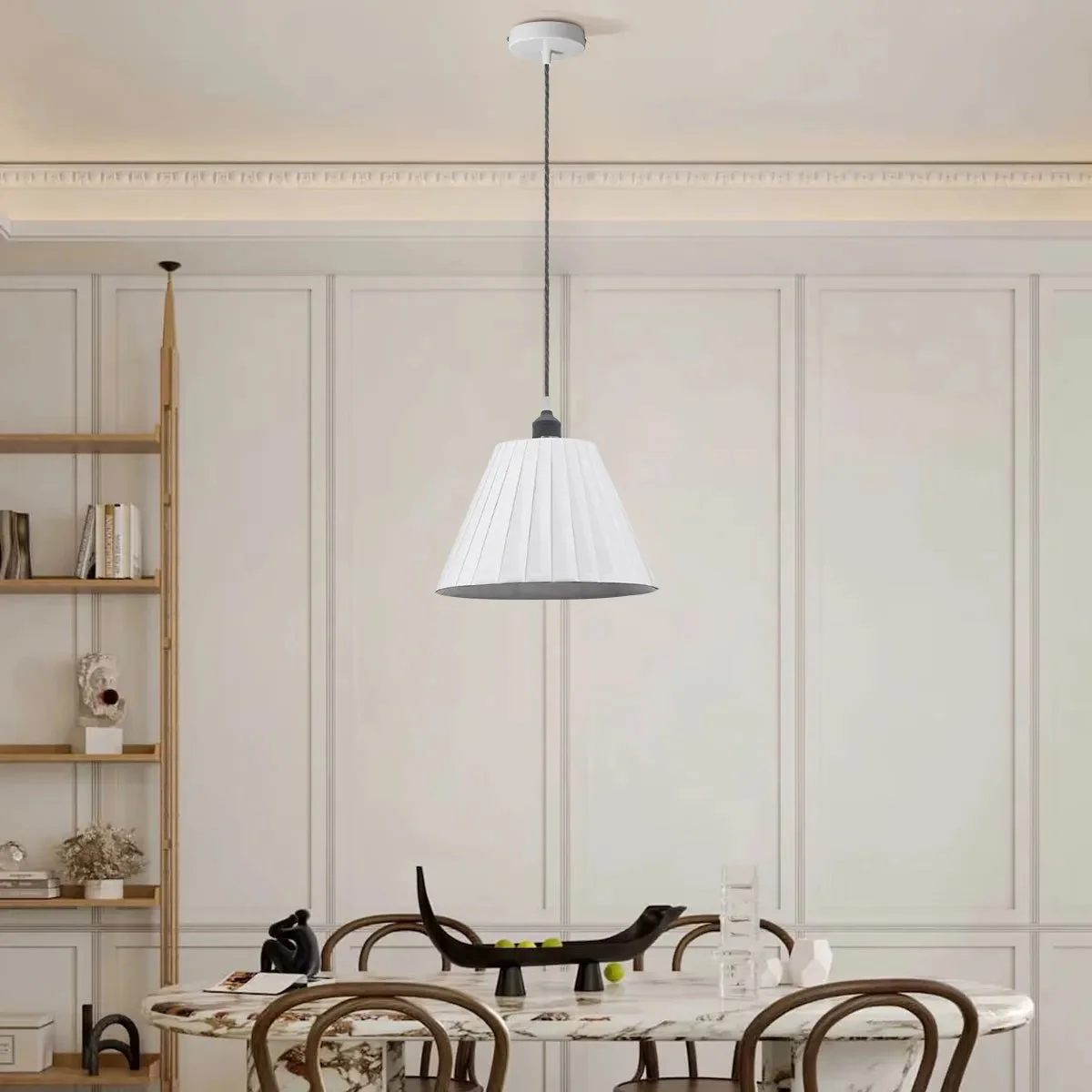 White pleated fabric shade dimmable pendant lamp with metal frame and fabric-covered cable hanging from ceiling
