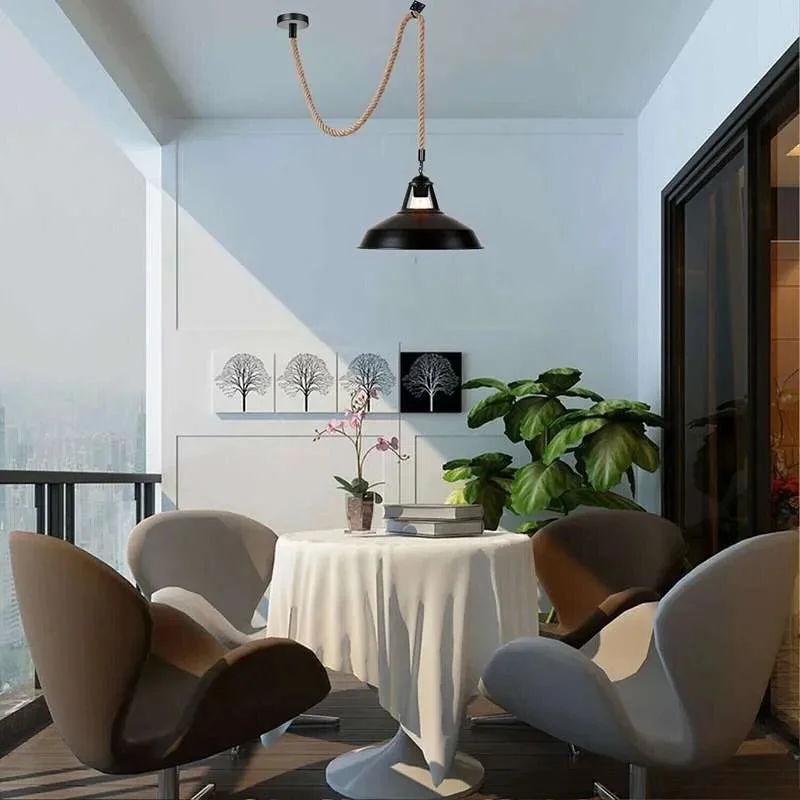 Black metal pendant light with adjustable hemp cable light hanging against a white background, showing full length and shade details